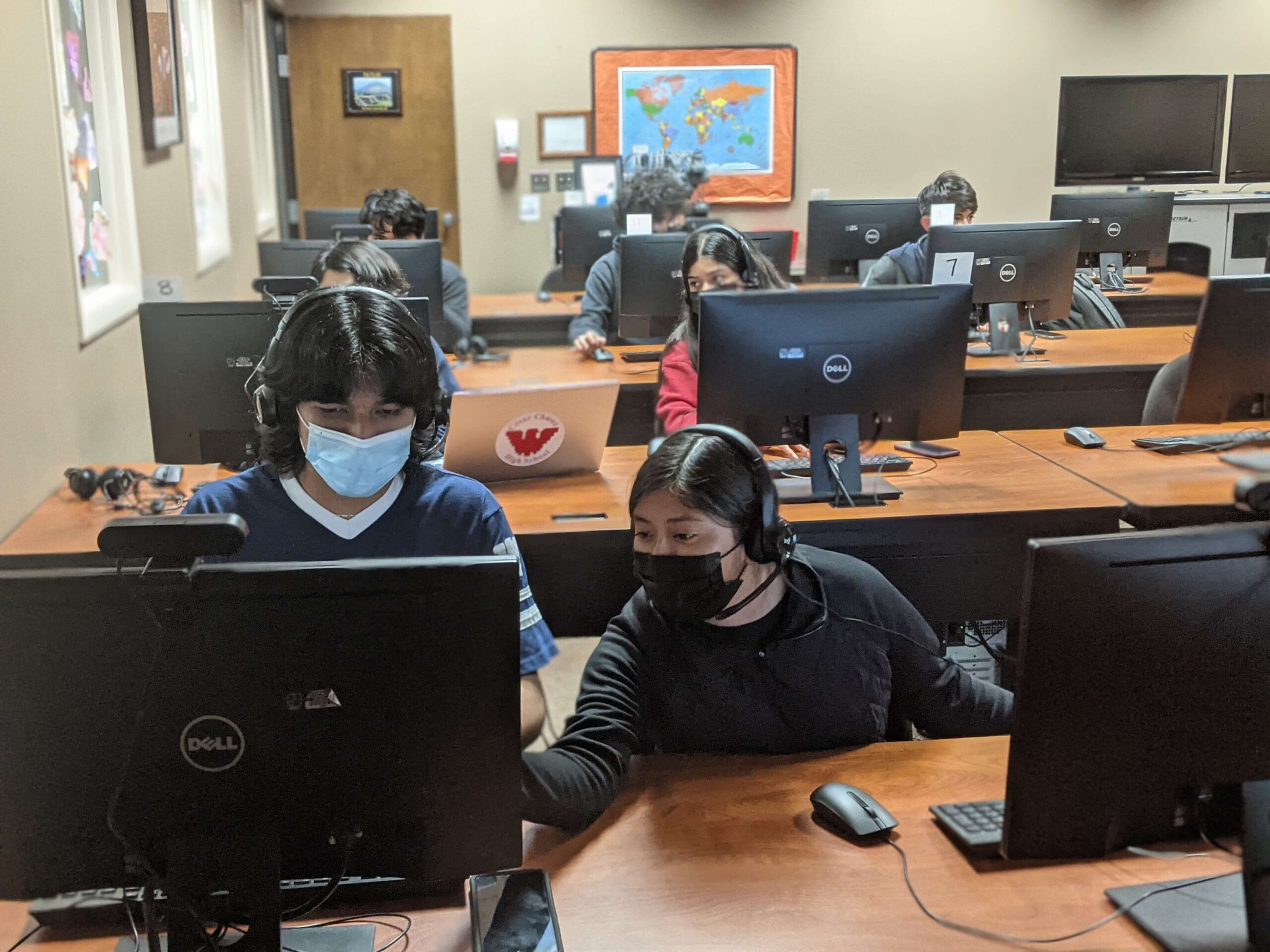 Teens in a computer workshop, working together in the Best Buy Center 